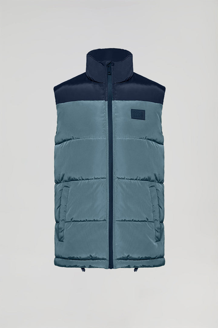 Denim-blue puffer vest with high collar and logo patch