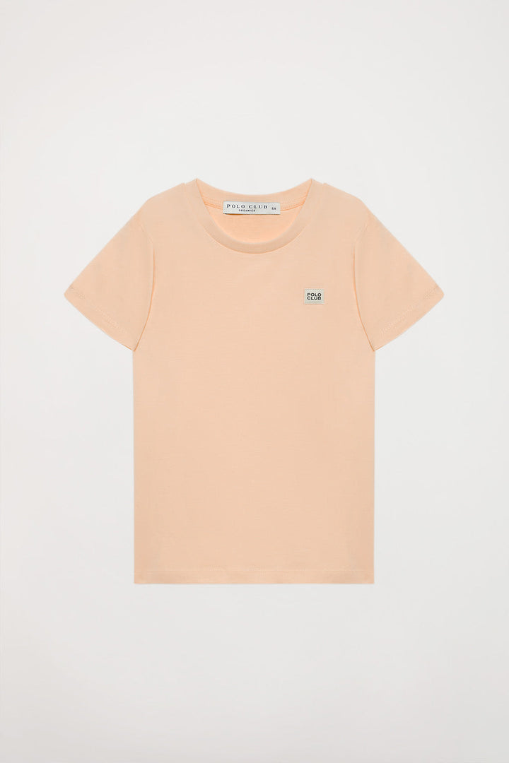 Organiczna koszulka Neutrals kids w kolorze brzoskwiniowym z krótkim rękawem i logo